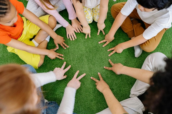 Group of toddlers collaboratively playing with colorful building blocks, developing fine motor skills and creativity at Quokka Kids