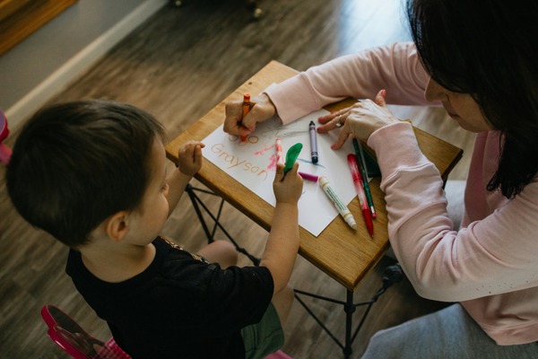 Group of toddlers collaboratively playing with colorful building blocks, developing fine motor skills and creativity at Quokka Kids